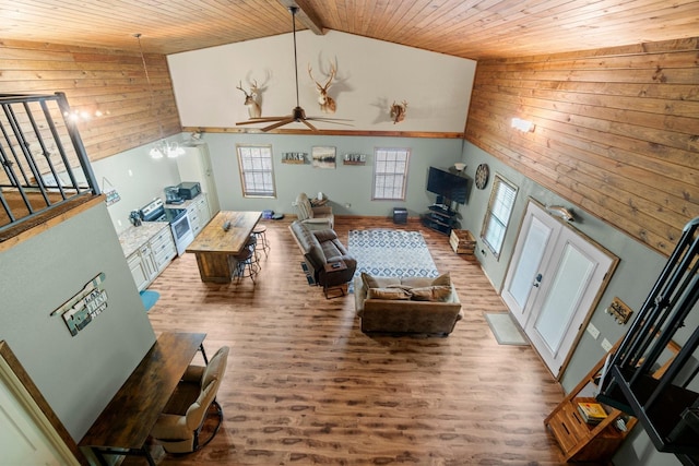 51 Roatan Dr, Point Blank, TX 77364 - living room featuring wooden walls, wooden ceiling, wood finished floors, stairs, and high vaulted ceiling
