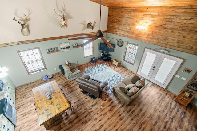 51 Roatan Dr, Point Blank, TX 77364 - living area featuring ceiling fan, wood finished floors, wooden walls, a towering ceiling, and french doors