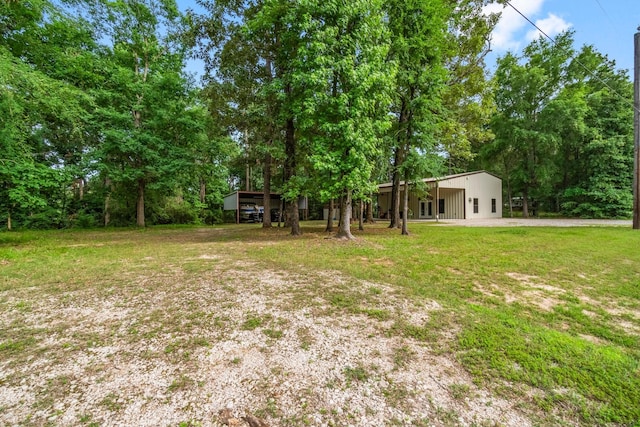 51 Roatan Dr, Point Blank, TX 77364 - view of green lawn with a carport