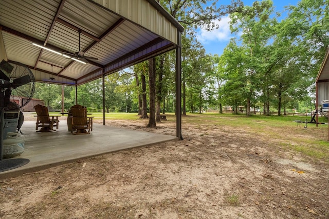 51 Roatan Dr, Point Blank, TX 77364 - view of yard featuring ceiling fan, a patio area, and view of scattered trees
