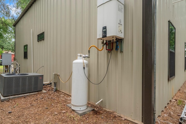 51 Roatan Dr, Point Blank, TX 77364 - view of property exterior with central air condition unit and tankless water heater