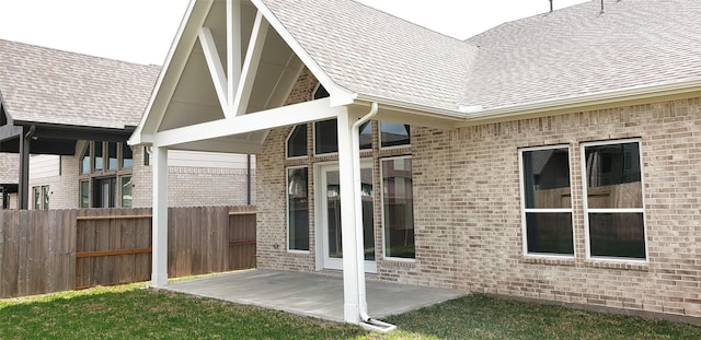 10611 Hidden Rock Dr, Missouri City, TX 77459 - rear view of property with brick siding, fence, a patio, and roof with shingles