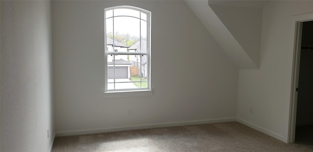 10611 Hidden Rock Dr, Missouri City, TX 77459 - additional living space with plenty of natural light, carpet, baseboards, and lofted ceiling
