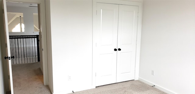 10611 Hidden Rock Dr, Missouri City, TX 77459 - unfurnished bedroom featuring light carpet, a closet, and baseboards