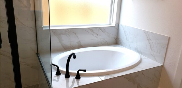 10611 Hidden Rock Dr, Missouri City, TX 77459 - bathroom featuring a garden tub and a marble finish shower