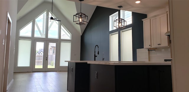 10611 Hidden Rock Dr, Missouri City, TX 77459 - kitchen featuring high vaulted ceiling, pendant lighting, light wood-style floors, ceiling fan, and recessed lighting