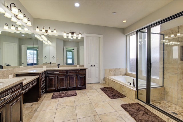 bathroom with a bath, vanity, recessed lighting, a shower stall, and tile patterned floors