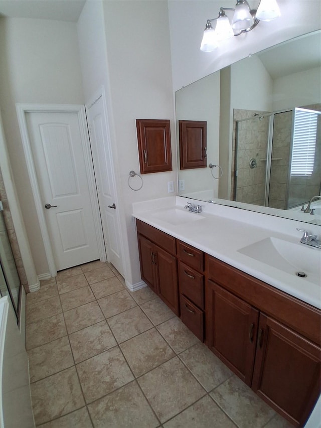 24911 Tribeca Ln, Katy, TX 77493 - bathroom featuring a tile shower, tile patterned flooring, and double vanity