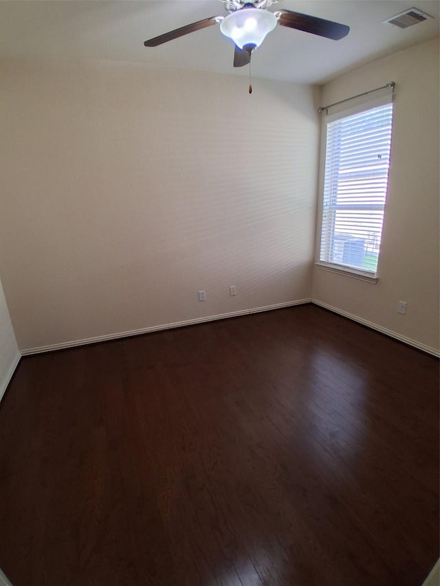 24911 Tribeca Ln, Katy, TX 77493 - unfurnished room with dark wood finished floors, ceiling fan, and baseboards
