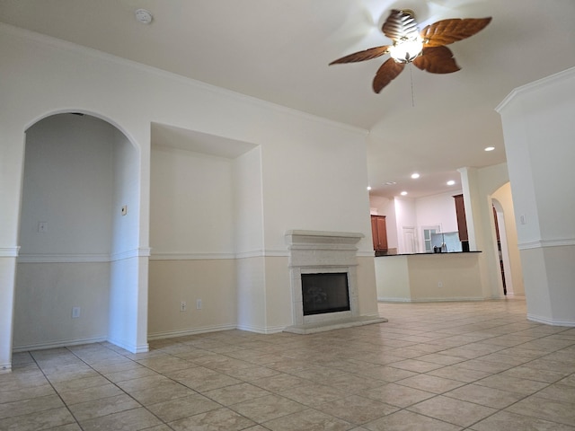 24911 Tribeca Ln, Katy, TX 77493 - unfurnished living room with ceiling fan, arched walkways, recessed lighting, ornamental molding, and light tile patterned floors