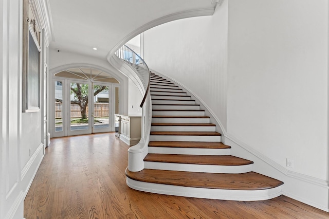 6104 San Felipe St, Houston, TX 77057 - stairway featuring wood finished floors, recessed lighting, and arched walkways