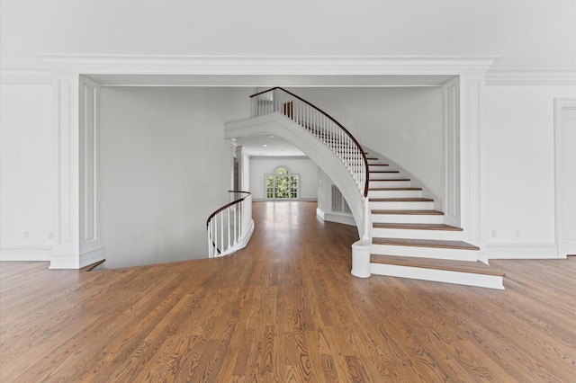 6104 San Felipe St, Houston, TX 77057 - foyer entrance featuring wood finished floors, ornamental molding, baseboards, and arched walkways
