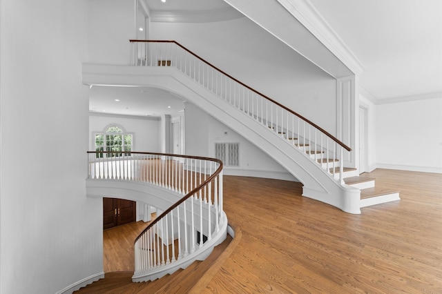 6104 San Felipe St, Houston, TX 77057 - stairs featuring ornamental molding, wood finished floors, baseboards, and a high ceiling