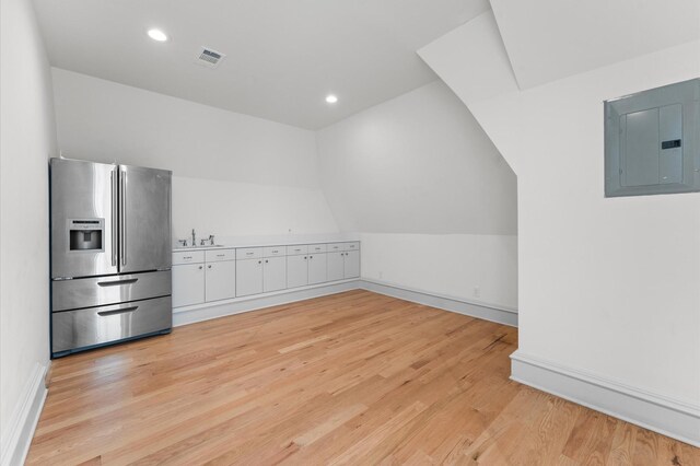 6104 San Felipe St, Houston, TX 77057 - additional living space with electric panel, light wood finished floors, a sink, baseboards, and lofted ceiling