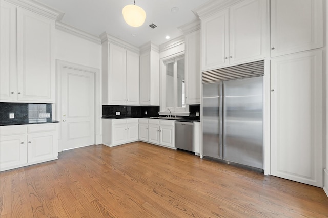 6104 San Felipe St, Houston, TX 77057 - kitchen with stainless steel appliances, dark countertops, a sink, tasteful backsplash, and recessed lighting
