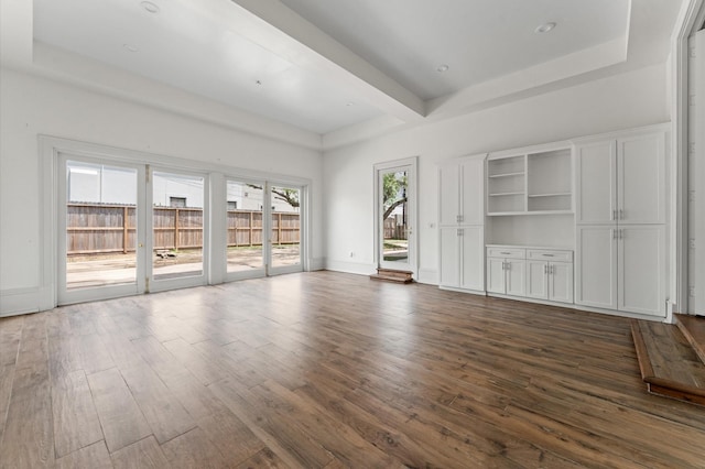 6104 San Felipe St, Houston, TX 77057 - unfurnished living room featuring dark wood-style flooring, a raised ceiling, and baseboards