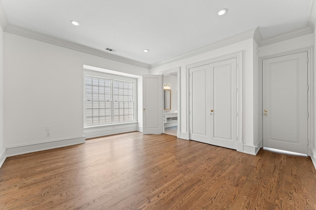 6104 San Felipe St, Houston, TX 77057 - unfurnished bedroom with crown molding, recessed lighting, wood finished floors, baseboards, and connected bathroom