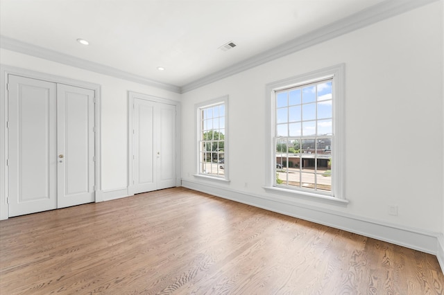 6104 San Felipe St, Houston, TX 77057 - unfurnished bedroom with multiple closets, light wood-type flooring, crown molding, recessed lighting, and baseboards