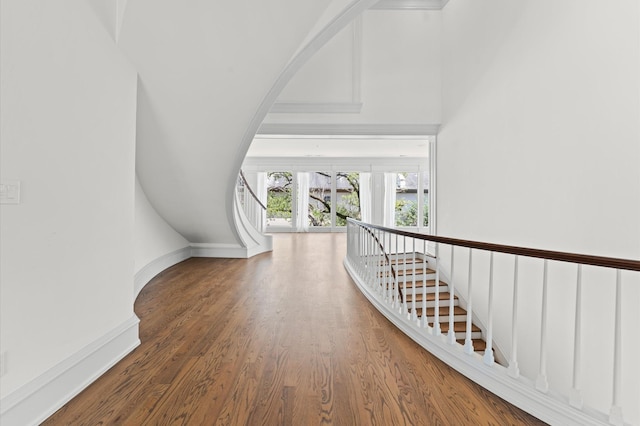 6104 San Felipe St, Houston, TX 77057 - hall with wood finished floors, arched walkways, and baseboards