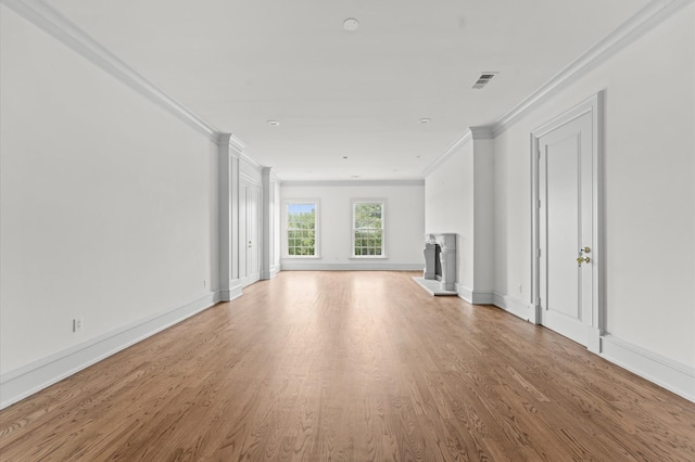 6104 San Felipe St, Houston, TX 77057 - unfurnished living room featuring crown molding, a fireplace with raised hearth, wood finished floors, and baseboards