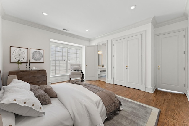 6104 San Felipe St, Houston, TX 77057 - bedroom featuring crown molding, wood finished floors, recessed lighting, connected bathroom, and baseboards