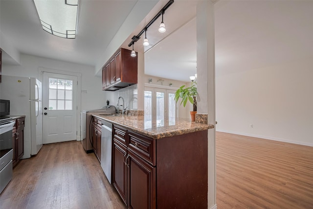 13040 Trail Hollow Dr Unit 3040, Houston, TX 77079 - kitchen with light wood finished floors, freestanding refrigerator, stainless steel dishwasher, black microwave, and rail lighting