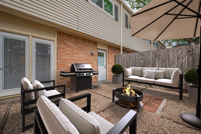13040 Trail Hollow Dr Unit 3040, Houston, TX 77079 - view of patio featuring area for grilling, an outdoor living space with a fire pit, and fence