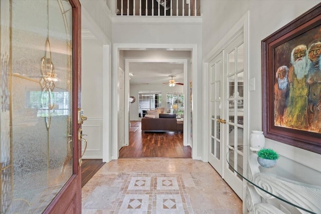 entryway featuring french doors and ceiling fan