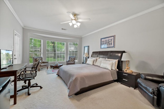 bedroom featuring crown molding, light colored carpet, an office area, and a ceiling fan