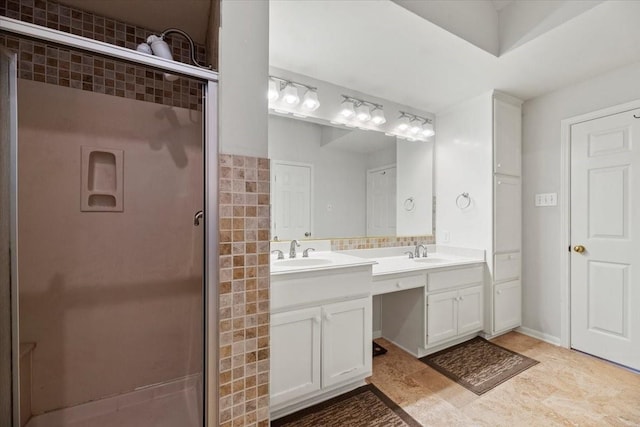full bath featuring vanity, tasteful backsplash, and a shower