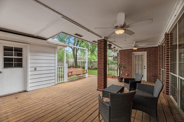 wooden deck featuring ceiling fan and fence