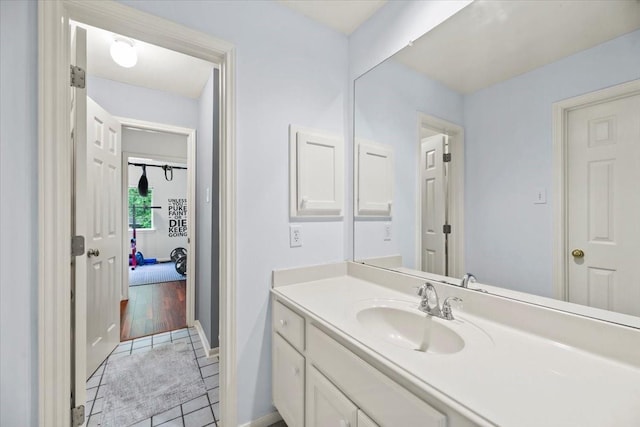 bathroom with tile patterned flooring, vanity, and baseboards