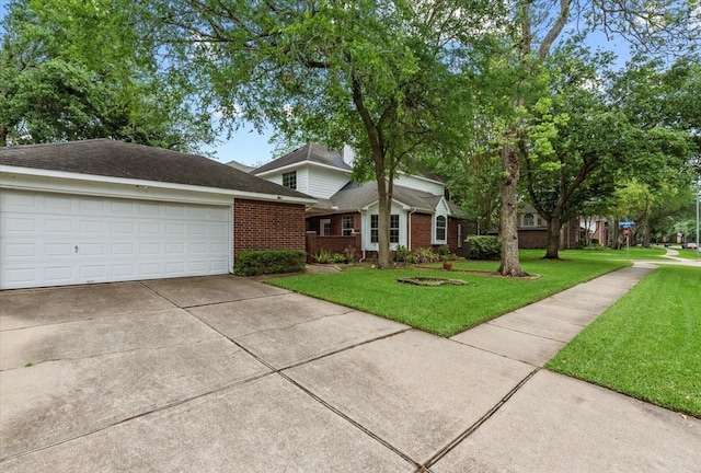 traditional home featuring brick siding, a front yard, driveway, and a garage