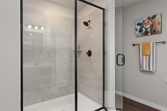 183 Lucky Manor Ln, La Porte, TX 77571 - bathroom with a shower stall, baseboards, and wood finished floors
