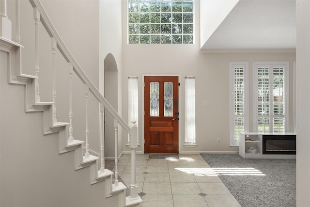 1409 Cherokee St, Deer Park, TX 77536 - foyer entrance with baseboards, tile patterned floors, stairway, and a towering ceiling