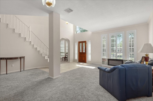 1409 Cherokee St, Deer Park, TX 77536 - living area featuring carpet flooring, arched walkways, baseboards, stairs, and ornamental molding