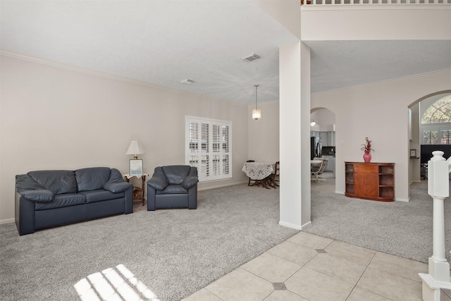 1409 Cherokee St, Deer Park, TX 77536 - carpeted living room with arched walkways, crown molding, baseboards, and tile patterned floors
