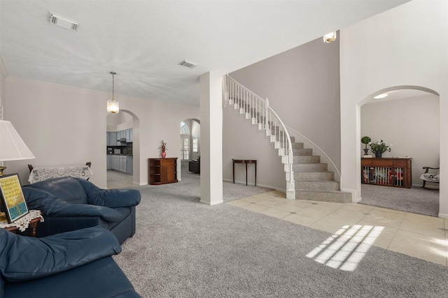 1409 Cherokee St, Deer Park, TX 77536 - living room with carpet flooring, arched walkways, baseboards, stairs, and crown molding