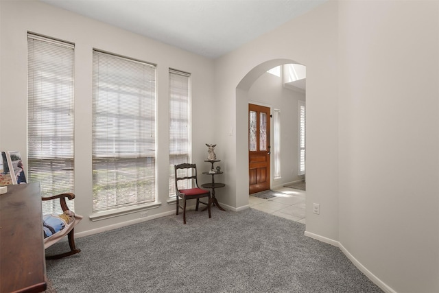 1409 Cherokee St, Deer Park, TX 77536 - living area with arched walkways, carpet floors, and baseboards