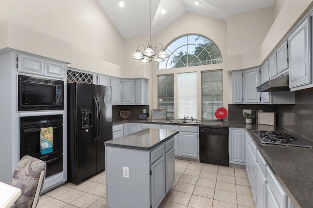 1409 Cherokee St, Deer Park, TX 77536 - kitchen with black appliances, gray cabinetry, under cabinet range hood, dark countertops, and high vaulted ceiling