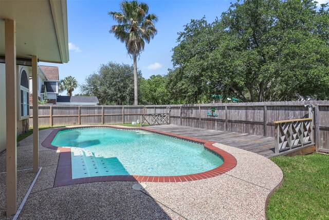 1409 Cherokee St, Deer Park, TX 77536 - view of pool with a fenced backyard, a patio, and a deck
