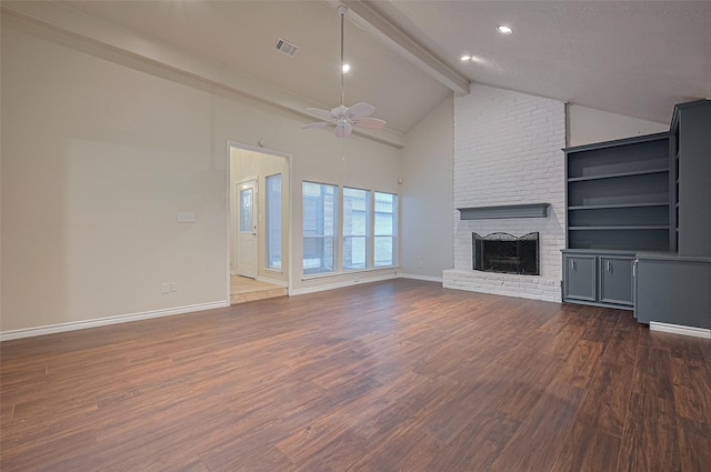 520 S Rivershire Dr, Conroe, TX 77304 - unfurnished living room featuring beam ceiling, ceiling fan, baseboards, dark wood-type flooring, and a fireplace