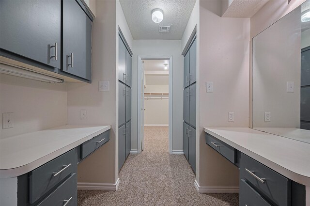 520 S Rivershire Dr, Conroe, TX 77304 - kitchen featuring light carpet, light countertops, a textured ceiling, and baseboards