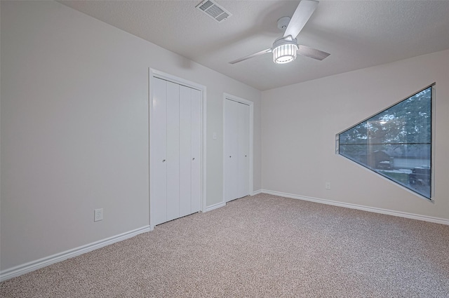 520 S Rivershire Dr, Conroe, TX 77304 - unfurnished bedroom with light colored carpet, baseboards, a ceiling fan, and a textured ceiling
