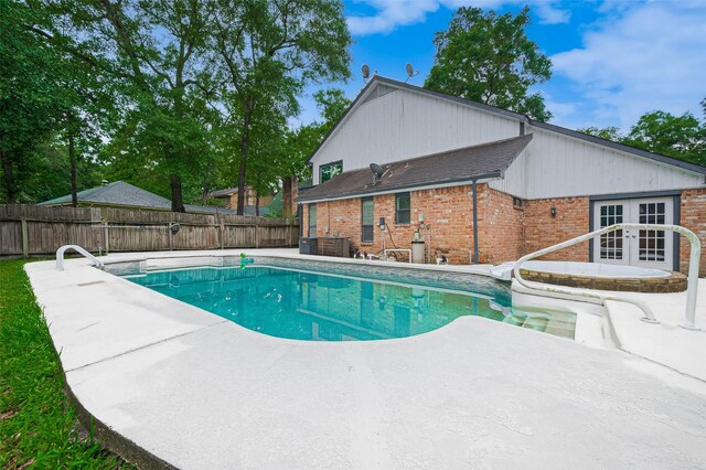520 S Rivershire Dr, Conroe, TX 77304 - view of swimming pool with french doors, a patio, and a fenced backyard