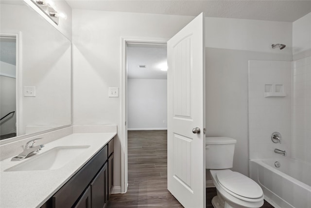 full bath featuring toilet, wood finished floors, vanity, and bathing tub / shower combination