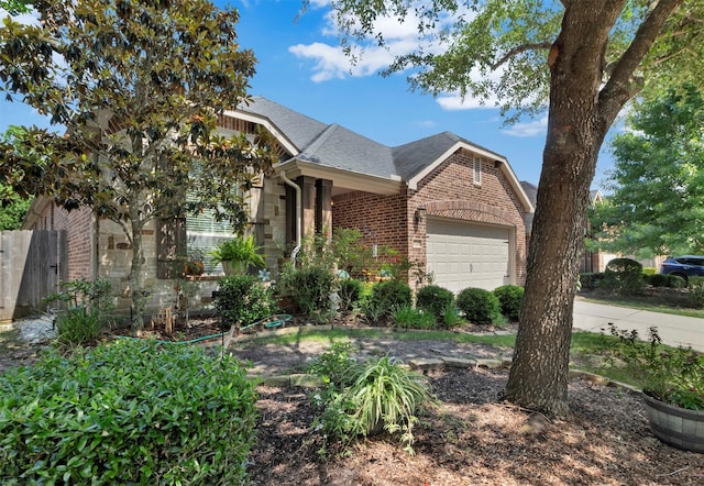 17219 Rookery Ct, Conroe, TX 77385 - view of front facade with brick siding, a garage, roof with shingles, and fence