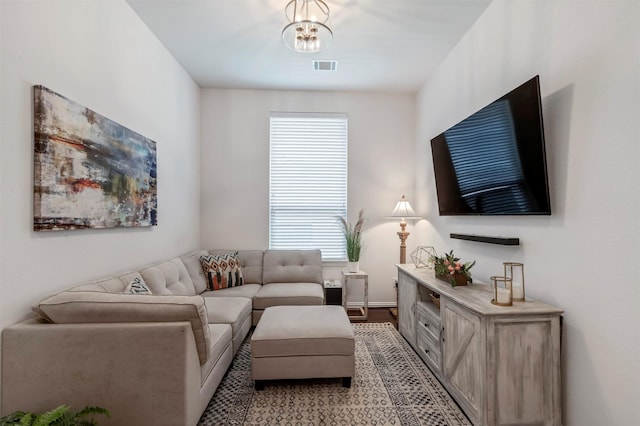 17219 Rookery Ct, Conroe, TX 77385 - living room featuring a chandelier, baseboards, and light wood-style flooring