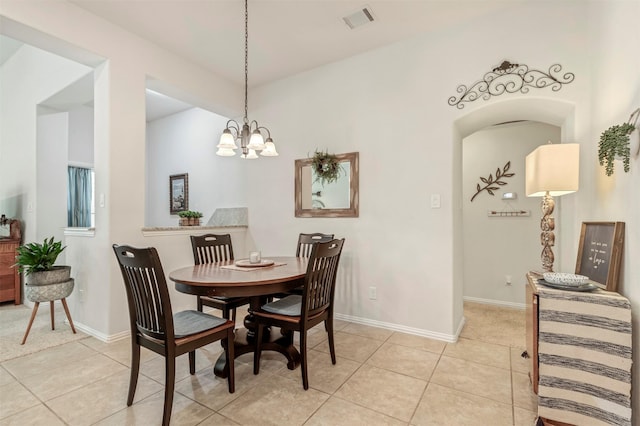 17219 Rookery Ct, Conroe, TX 77385 - dining space featuring light tile patterned floors, a chandelier, and baseboards