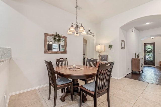 17219 Rookery Ct, Conroe, TX 77385 - dining room with arched walkways, light tile patterned floors, and baseboards